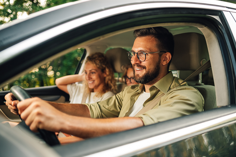 Happy couple driving in a car